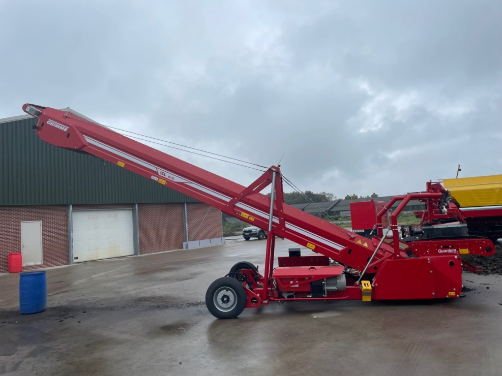 Rode landbouwmachine op boerenerf, regenachtige dag