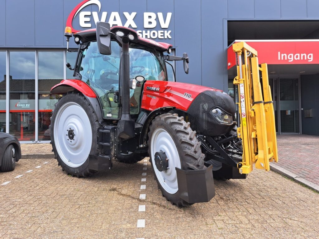 Rode tractor geparkeerd bij bedrijfsgebouw